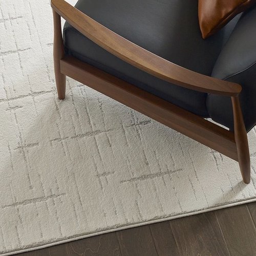 Room with hardwood flooring and a white textured rug from The Carpet Yard in McLean, VA