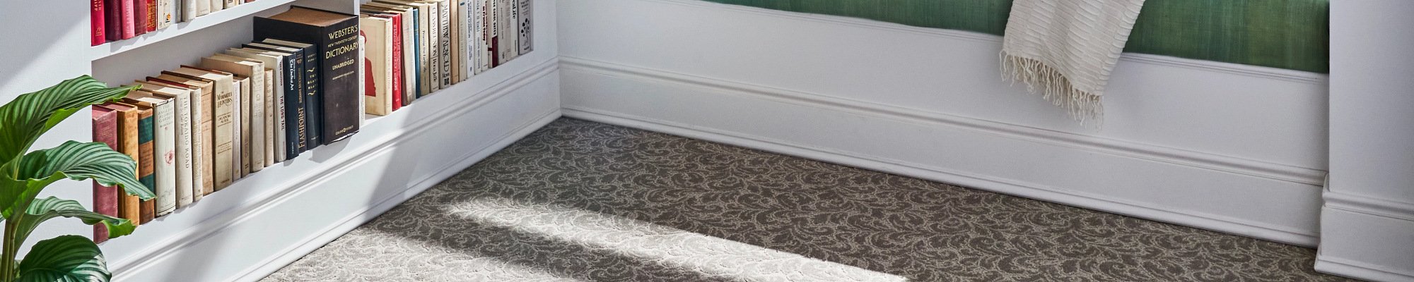 Person reading in window in a room with gray patterned carpet from The Carpet Yard in McLean, VA