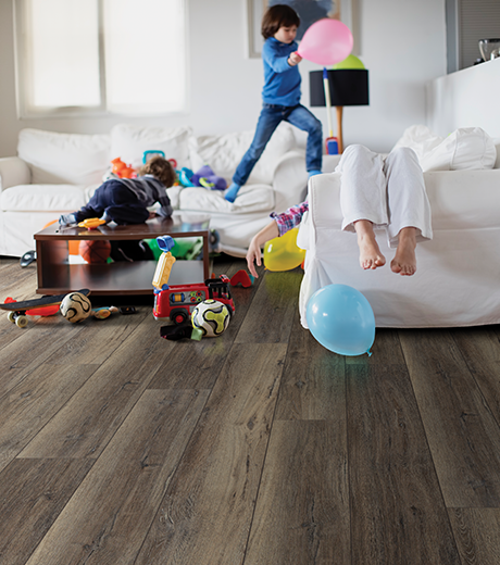 Kids playing in living room with wood-look luxury vinyl flooring from The Carpet Yard in McLean, VA