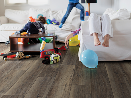 Kids playing in living room with wood-look luxury vinyl flooring from The Carpet Yard in McLean, VA